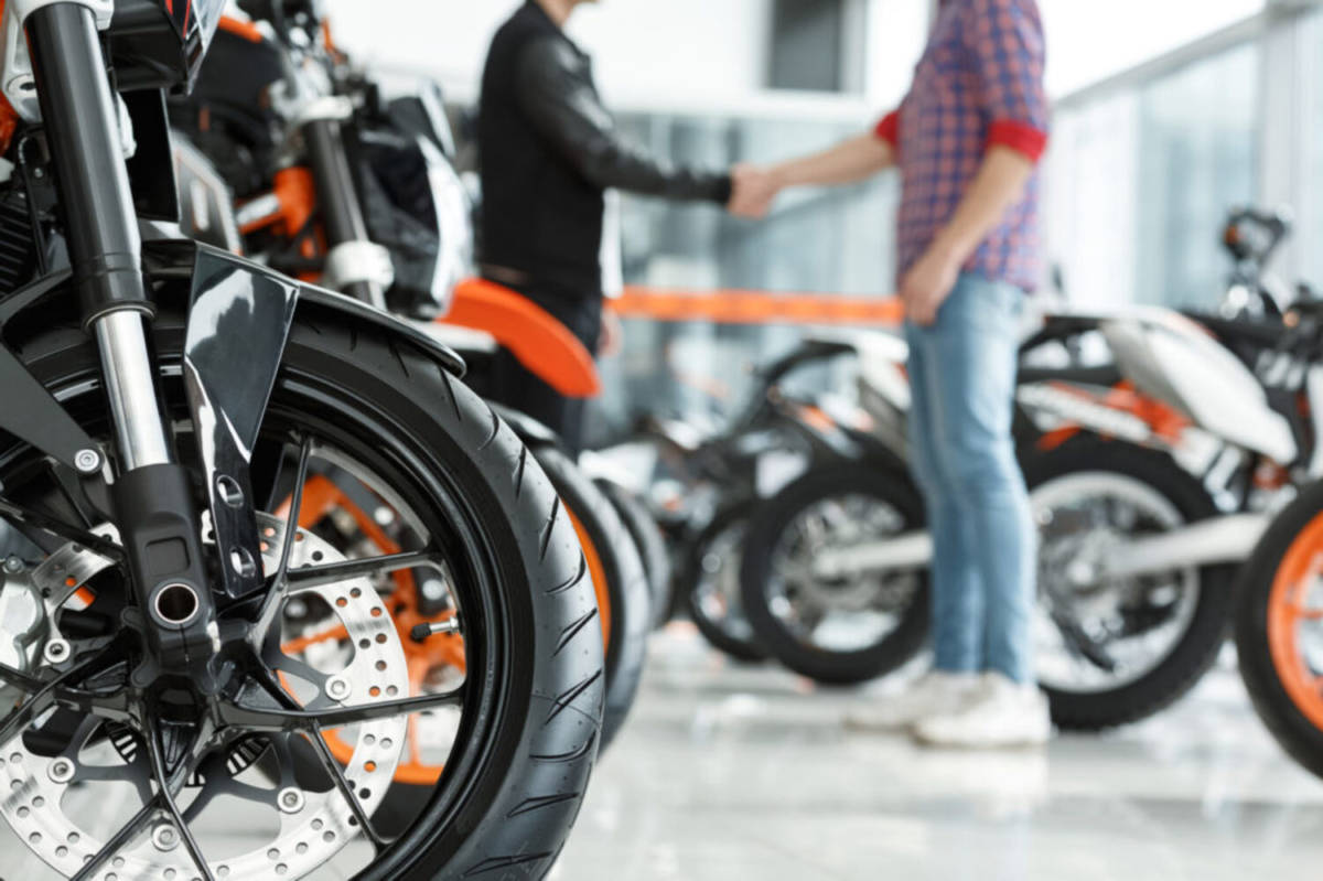 professionals closing the sale of a motorcycle