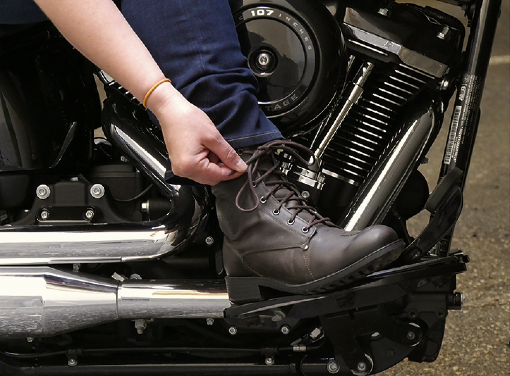 person putting on motorcycle boots